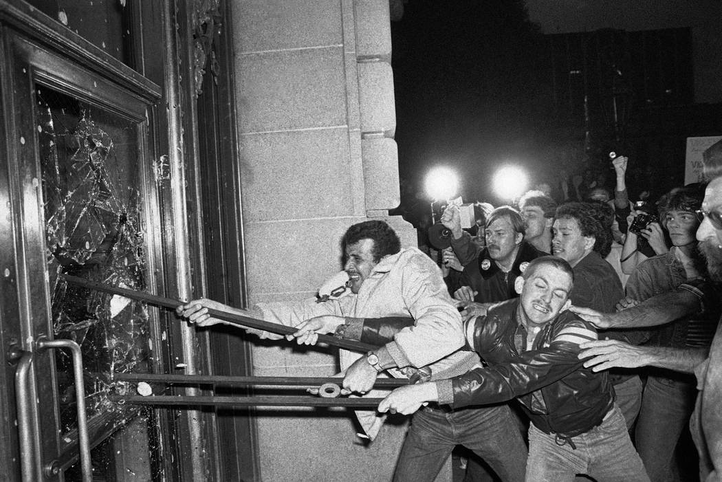 FILE - In this May 22, 1979 file photo, demonstrators smash glass out of the front doors of the ...