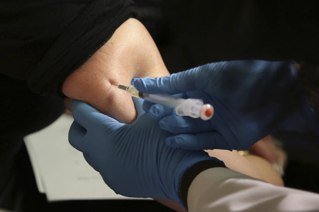 In this March 27, 2019 file photo, a woman receives a measles, mumps and rubella vaccine at the ...