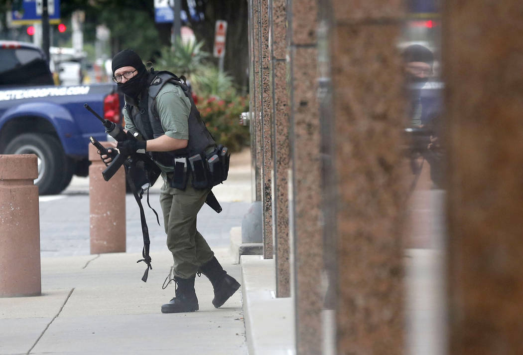 An armed shooter stands near the Earle Cabell Federal Building Monday, June 17, 2019, in downto ...