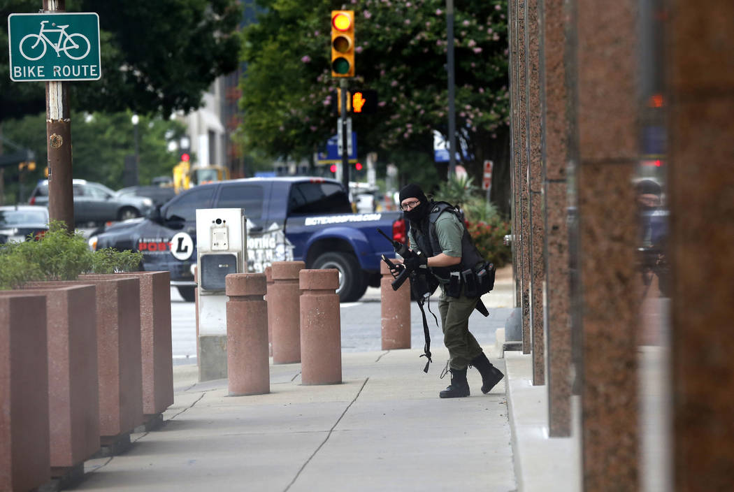 An armed shooter stands near the Earle Cabell Federal Building Monday, June 17, 2019, in downto ...