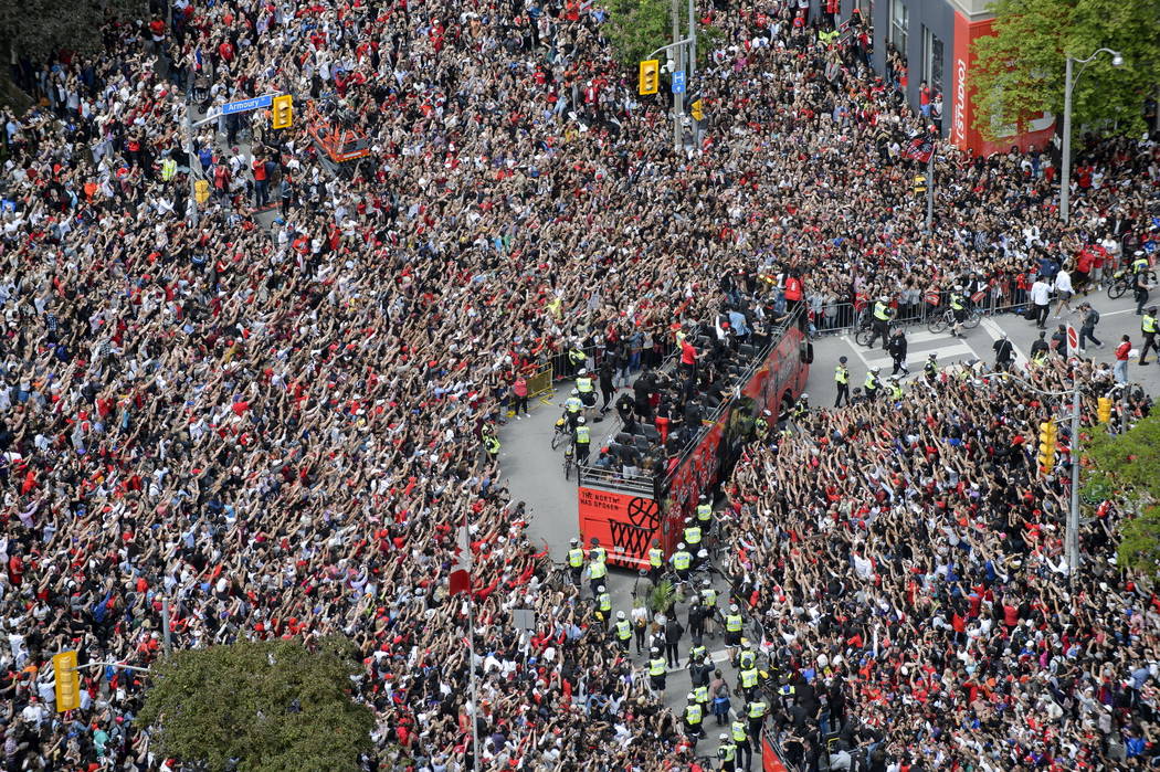 Fans cheer during the Toronto Raptors NBA basketball championship victory parade in Toronto, Mo ...