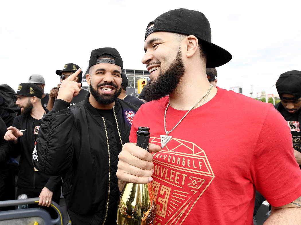 Toronto Raptors guard Fred VanVleet, right, celebrates with performing artist Drake during the ...