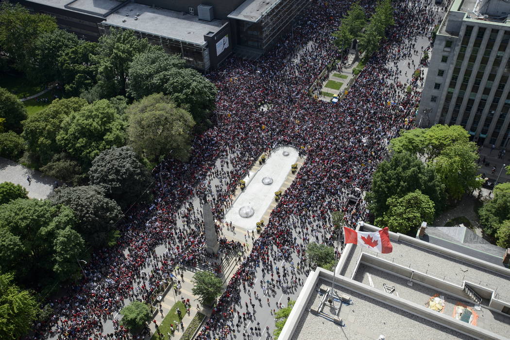 Fans fill the intersection of Queen St. West and University Avenue during the 2019 Toronto Rapt ...