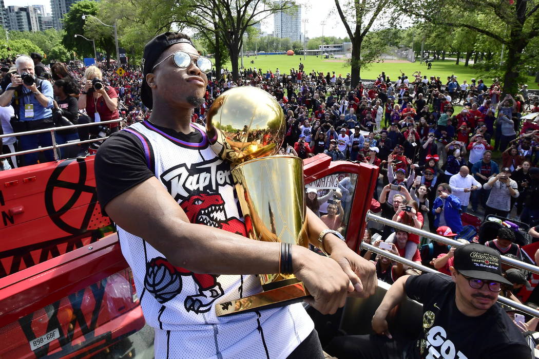 Toronto Raptors guard Kyle Lowry holds the Larry O'Brien Championship Trophy during the NBA bas ...