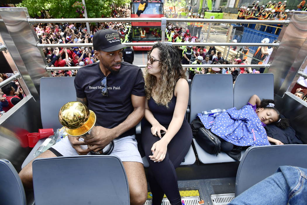 Toronto Raptors forward Kawhi Leonard and his girlfriend Kishele Shipley take a seat as their d ...