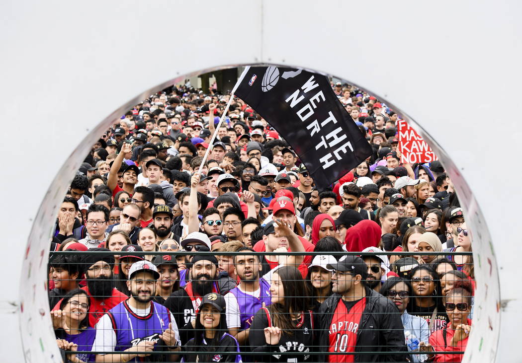 Thousands of fans gather to cheers on the Toronto Raptors during the NBA basketball team's cham ...