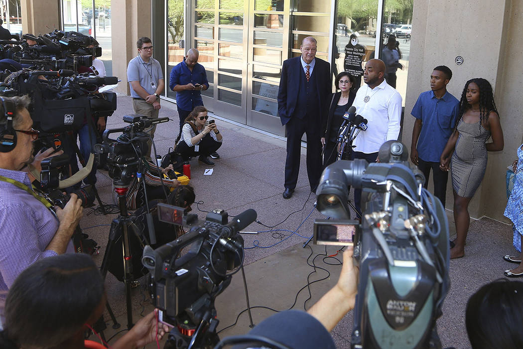 Rev. Jarrett Maupin, center, a civil rights advocate, speaks during a news conference as Dravon ...