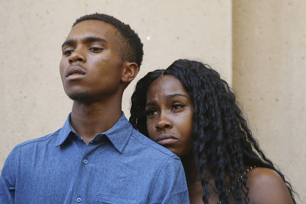 Dravon Ames, left, and Iesha Harper pause as they listen to a question during a news conference ...