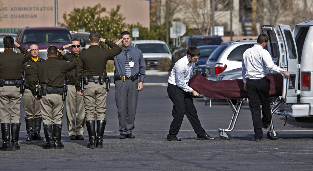 Las Vegas police officers form an honor guard for Stan Cooper, a slain U.S. Marshal officer, on ...