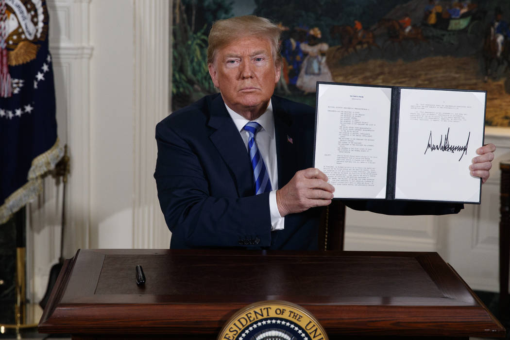 In a May 8, 2018, file photo President Donald Trump shows a signed Presidential Memorandum afte ...