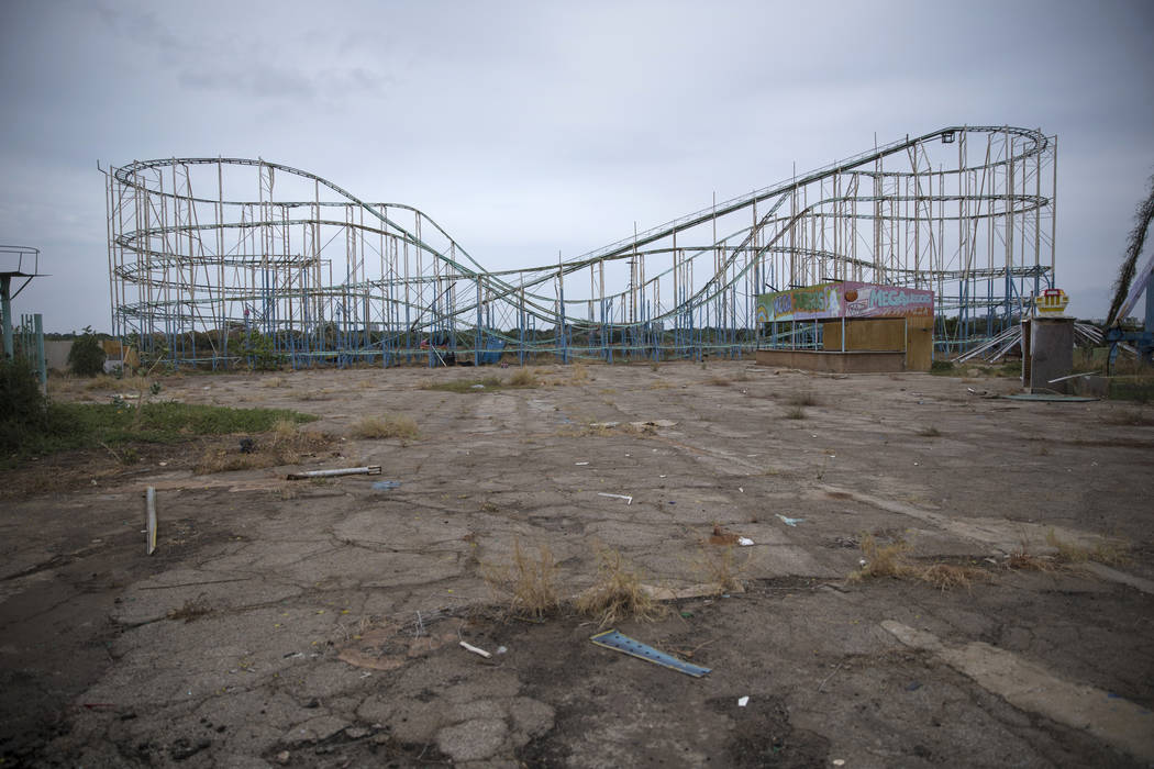 A roller coaster stands tall in the abandoned amusement park coined "Diversions Grano de O ...