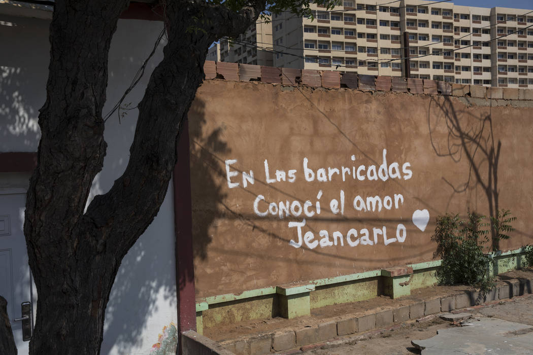 Spanish graffiti declares: I met love at the road blocks. Jeancarlo," referring to roadblo ...