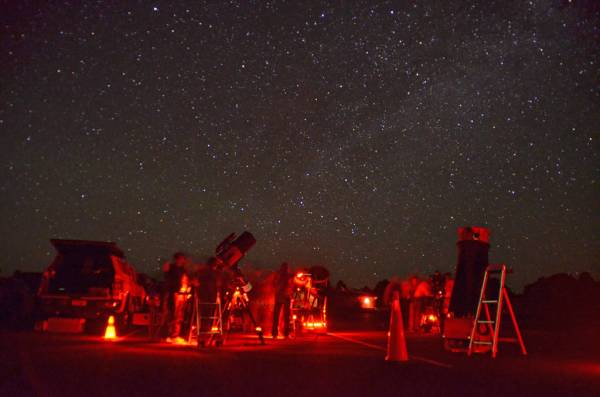 Red lights illuminate telescopes and stargazers during the annual Star Party at Grand Canyon Na ...