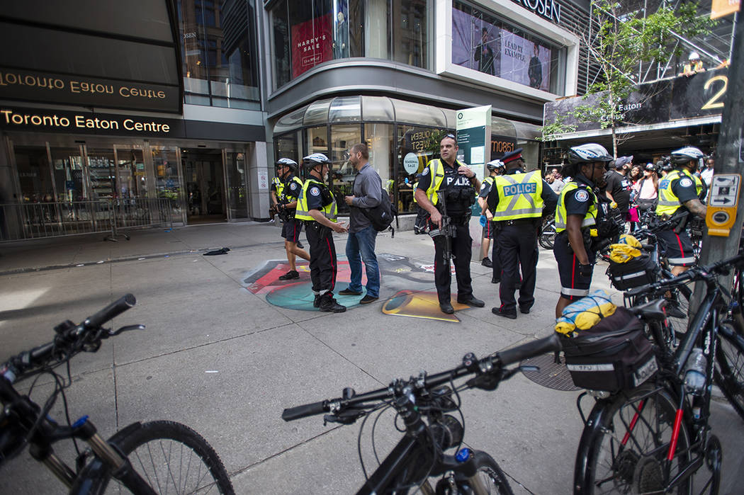 Toronto Police secure a crime scene after shots were fired during the Toronto Raptors NBA baske ...