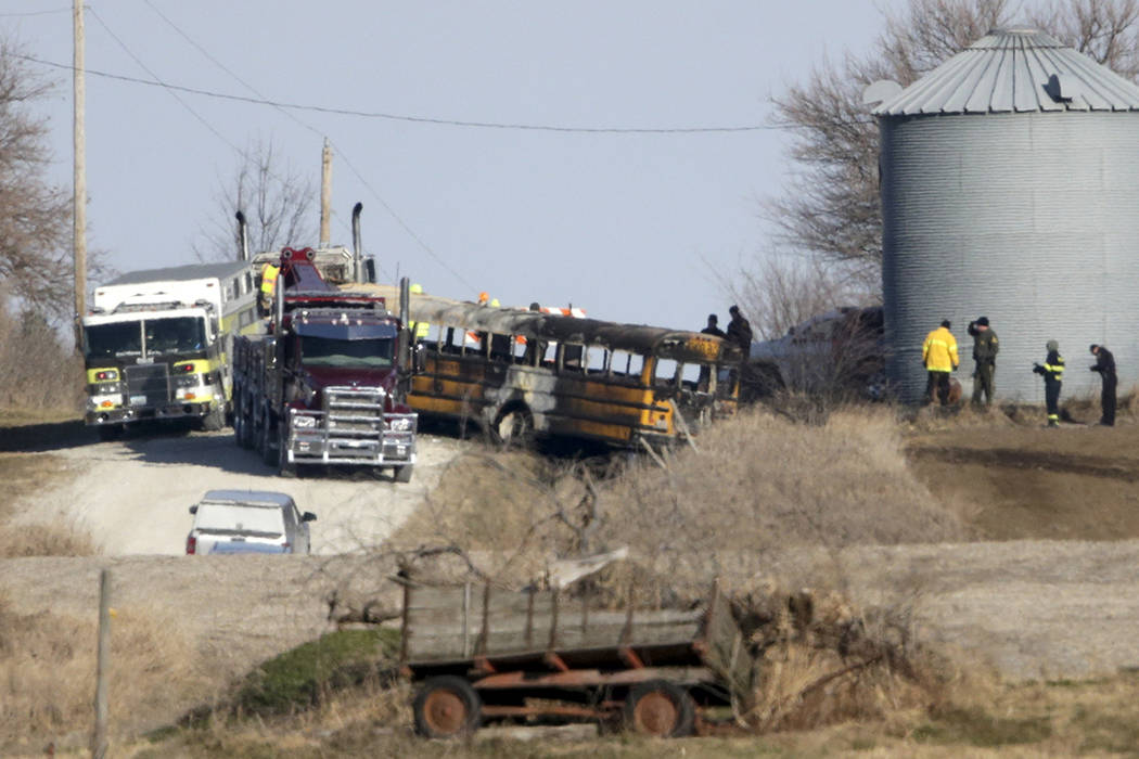 First responders work the scene of a school bus fire in Oakland, Iowa, Tuesday, Dec. 12, 2017. ...