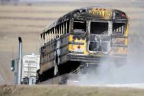 A burned school bus is transported by trailer near Oakland, Iowa, Tuesday, Dec. 12, 2017. A fir ...