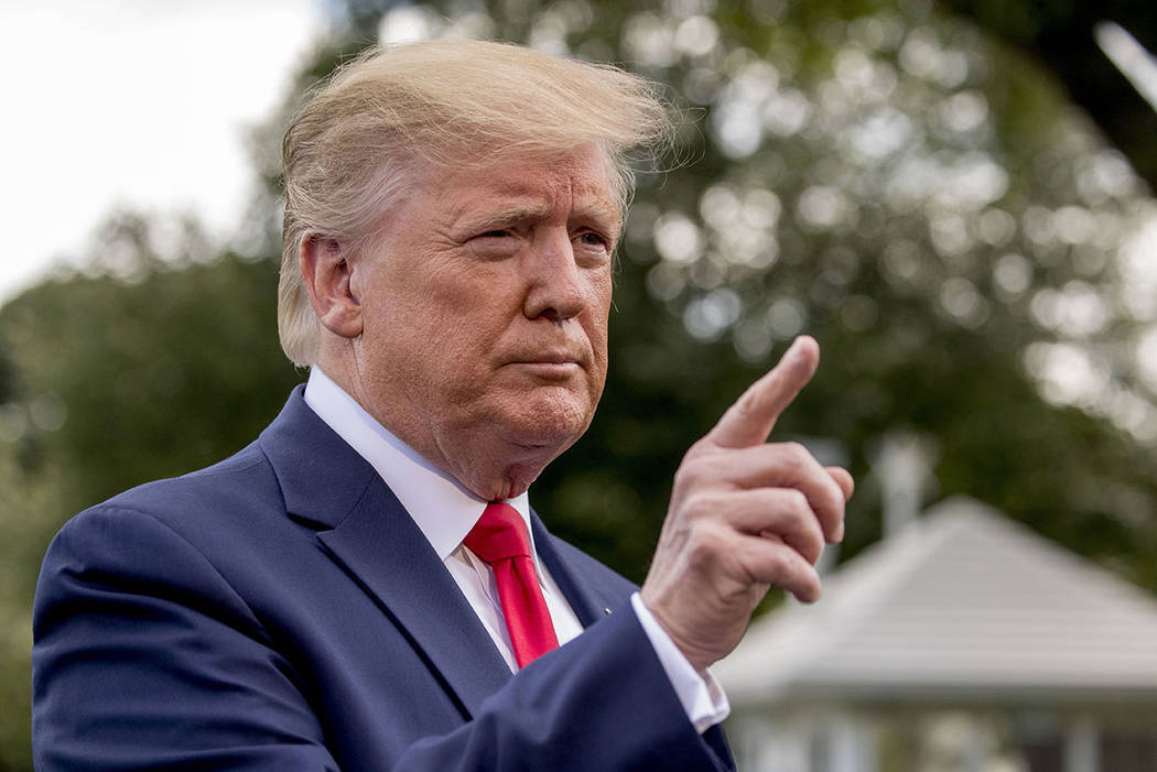 President Donald Trump calls on a reporter before boarding Marine One on the South Lawn of the ...