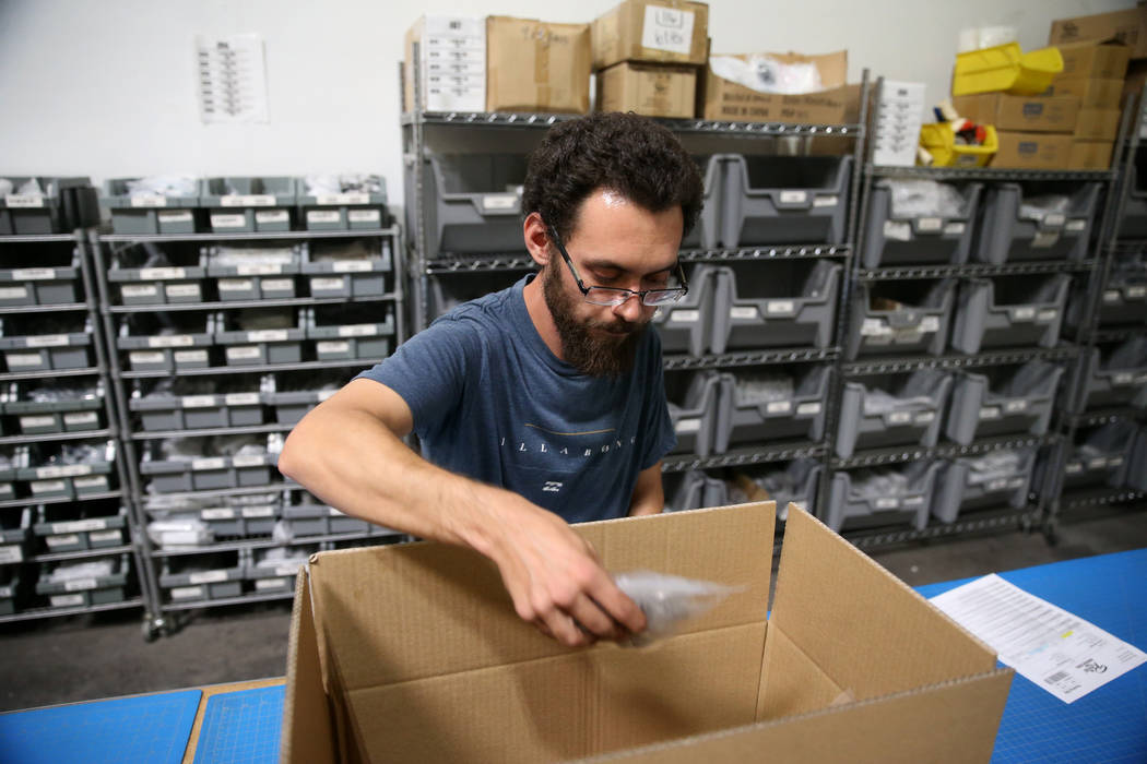 Warehouse associate Thomas Shirley fills an order at Retro Manufacturing headquarters in Hender ...