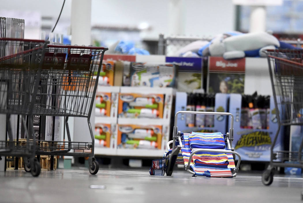 Scattered shopping carts and a flipped over beach chair lays on the ground following a shooting ...