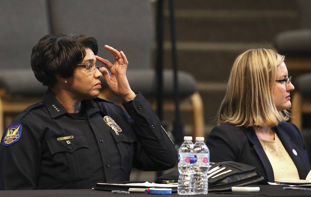 Phoenix Police Chief Jeri Williams, left, and Mayor Kate Gallego, right, listen to a speaker at ...