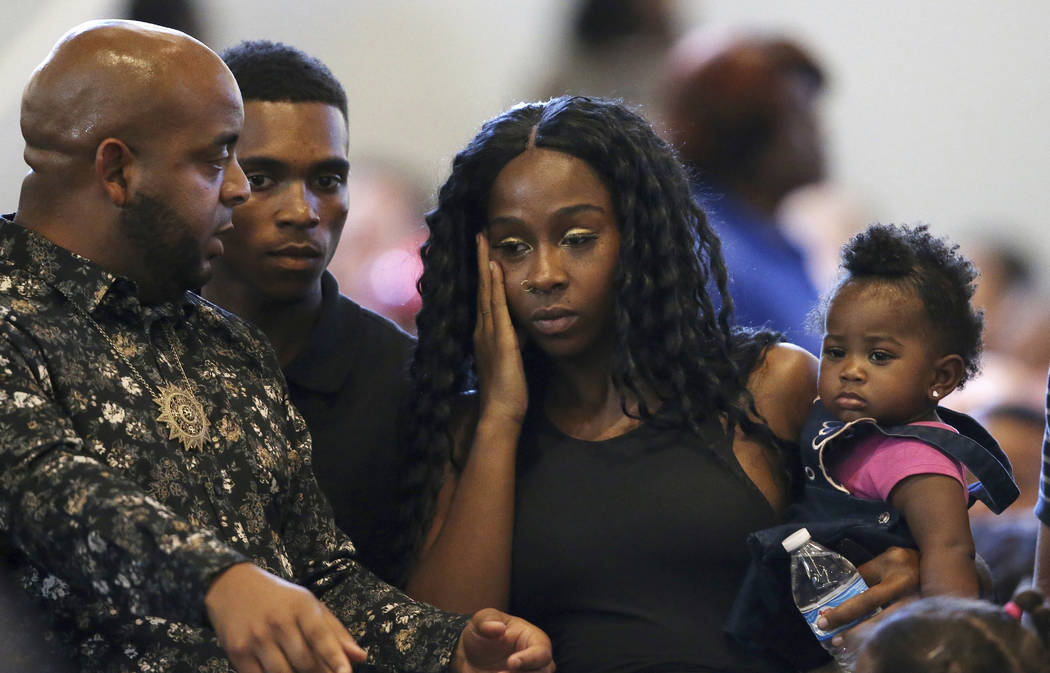 Rev. Jarrett Maupin, left, arrives with Dravon Ames, second from left, Iesha Harper, second fro ...