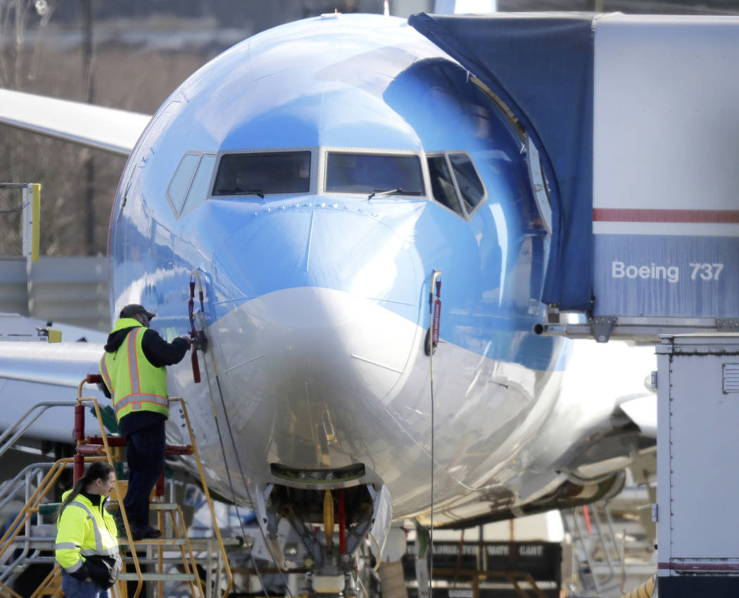 In a March 13, 2019, file photo a worker stands on a platform near a Boeing 737 MAX 8 airplane ...