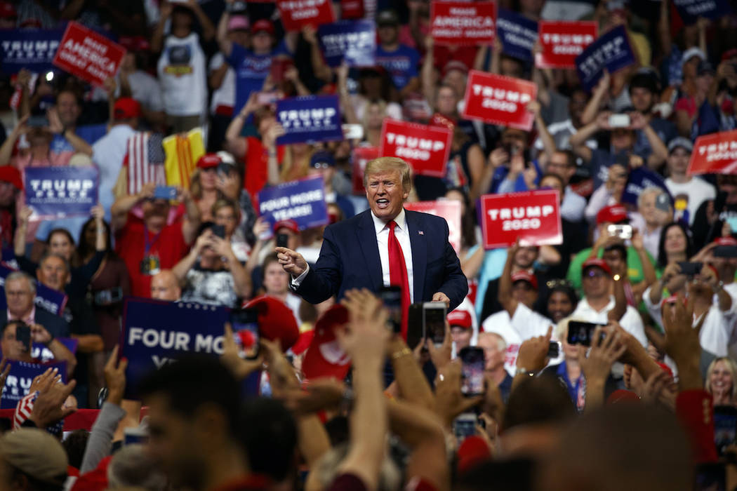 President Donald Trump reacts to the crowd after speaking during his re-election kickoff rally ...