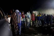 In an Aug. 31, 2018, file photo, Venezuelan migrants line up for free bread and coffee, donated ...