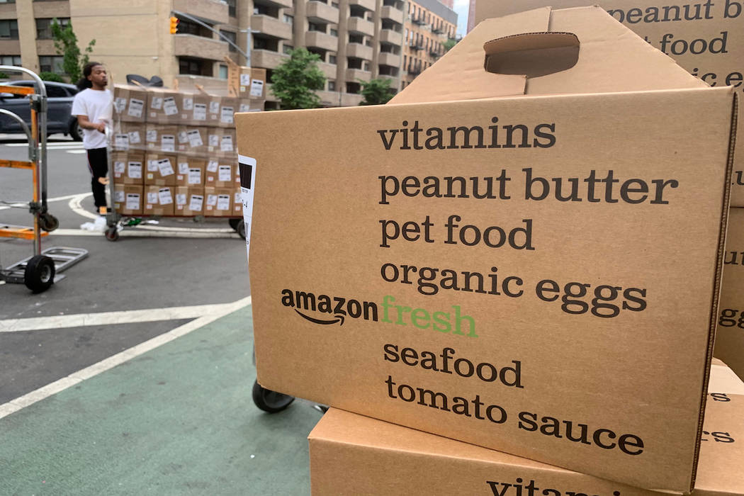 In this Sunday, June 16, 2019, boxes of Amazon Fresh deliveries are unloaded. (AP Photo/Jenny Kane)