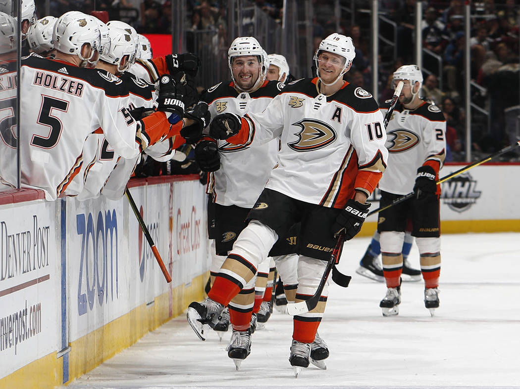 In this March 15, 2019, file photo, Anaheim Ducks right wing Corey Perry, right, is congratulat ...