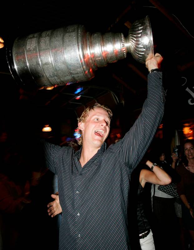 In this Aug. 10, 2007, file photo, Anaheim Ducks NHL hockey player Corey Perry lifts the Stanle ...