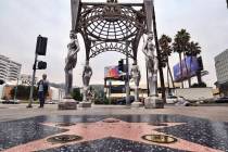 A pedestrian walks past the "Four Ladies of Hollywood" gazebo on Hollywood Boulevard ...