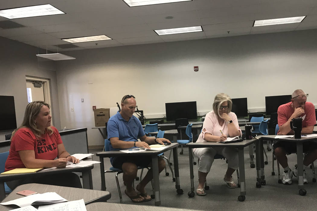 Assistant Principal Debra Berg, far left, discusses cuts with the school team at Bob Miller Mid ...