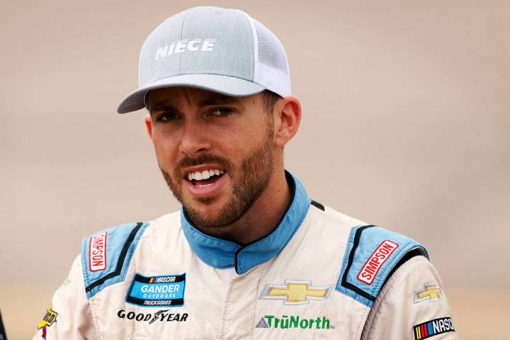 Ross Chastain walks to his truck before the start of the NASCAR Truck Series auto race, Sunday, ...