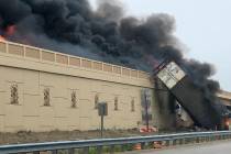 Smoke billows from a semi after a deadly crash on Interstate 94 in Caledonia, Wis., Wednesday, ...