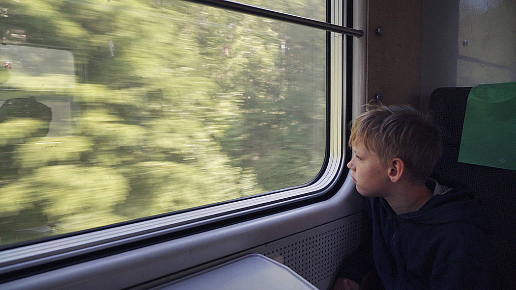 11-year-old Gabriel Bjorstrand looks out of the train window on the first of many trains on a w ...