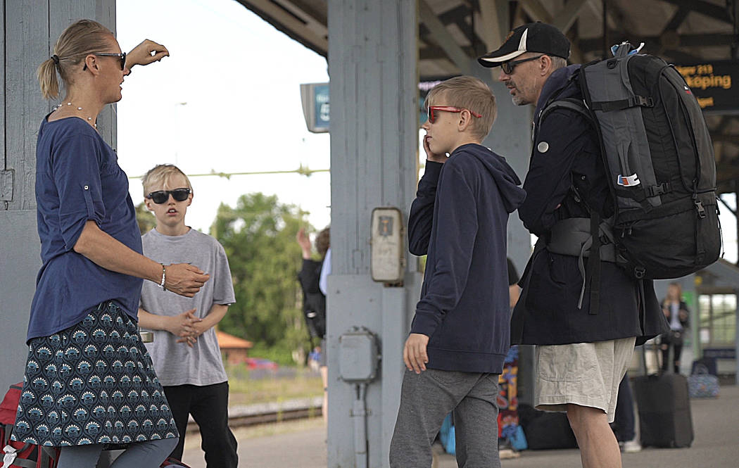 Swedish lawyer Pia Bjorstrand, her husband and their two sons await to board the first of many ...