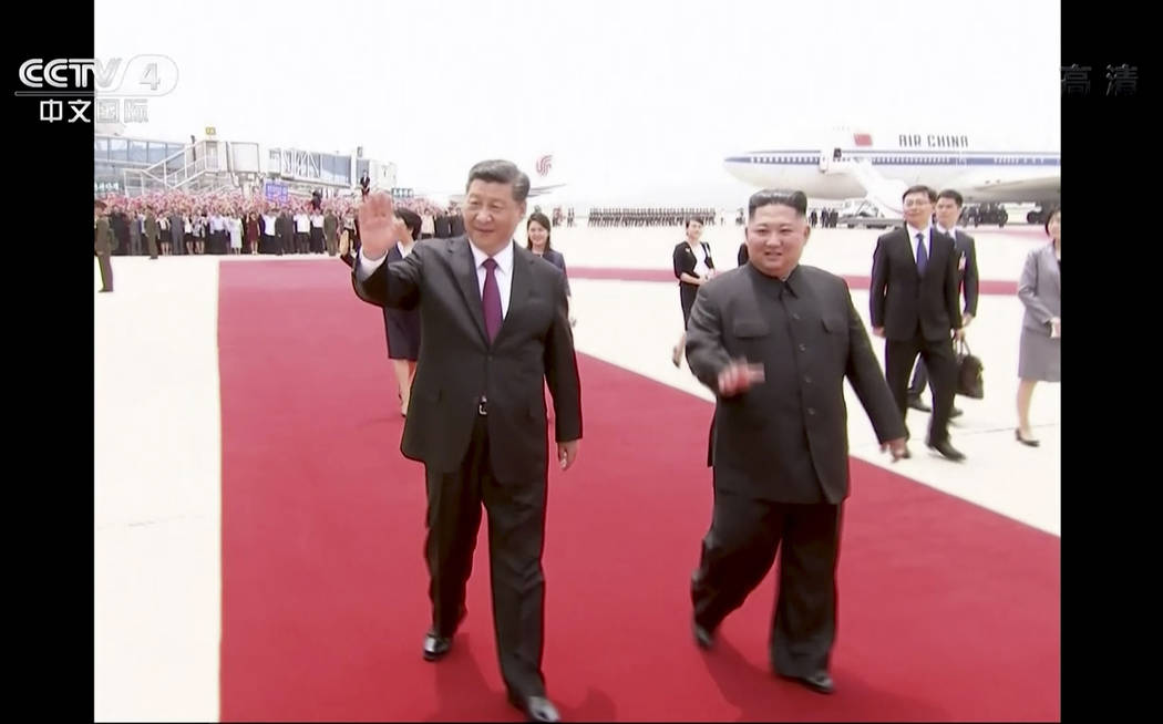 In this image taken from a video footage run by China's CCTV, Chinese President Xi Jinping, lef ...