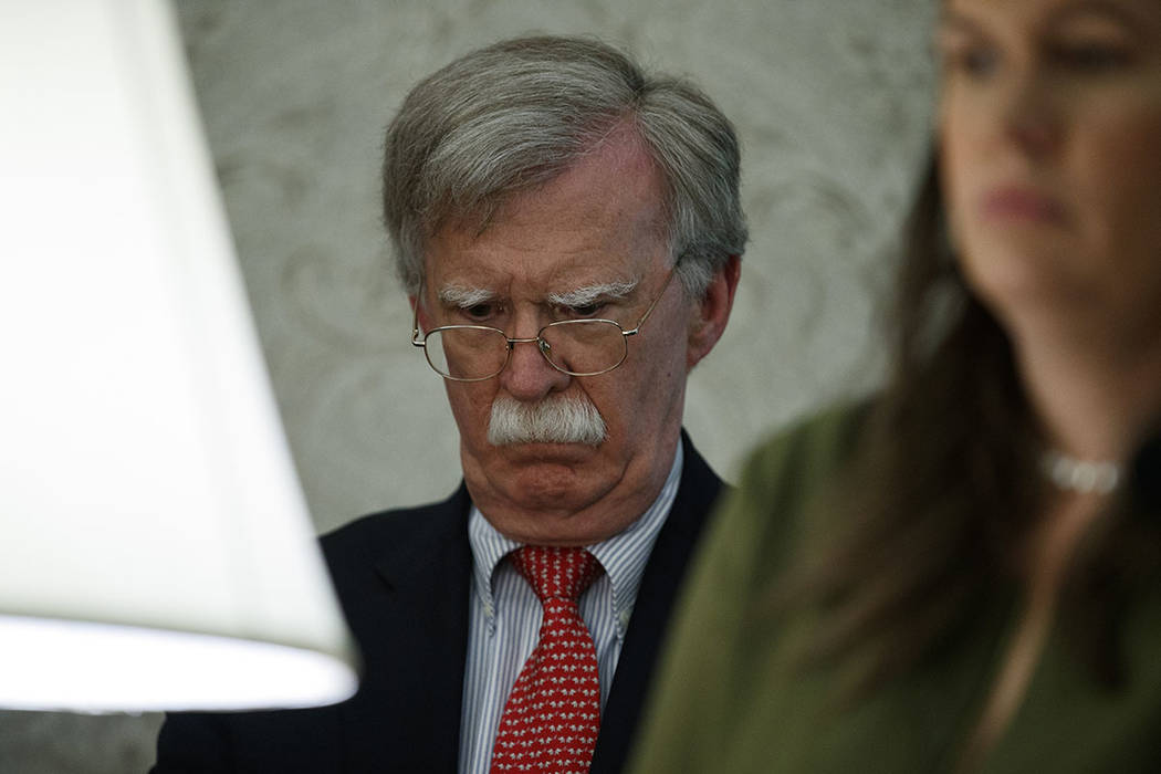 National security adviser John Bolton and White House press secretary Sarah Sanders listen to a ...