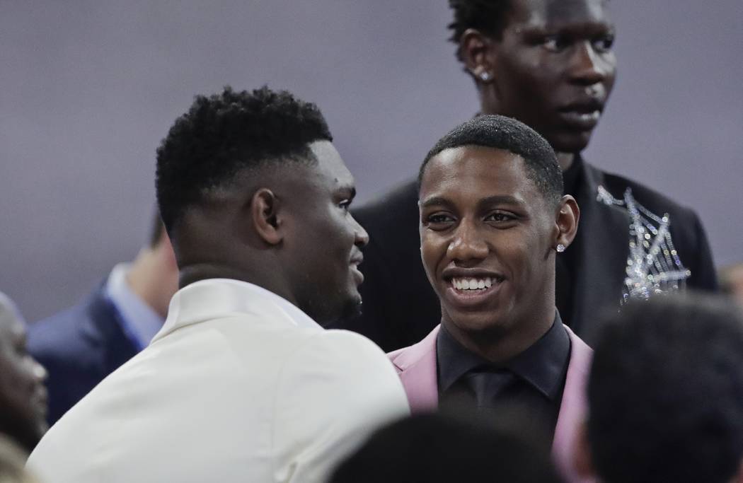 Duke's RJ Barrett, center, talks to Zion Williamson, as Oregon's Bol Bol, back, looks elsewhere ...