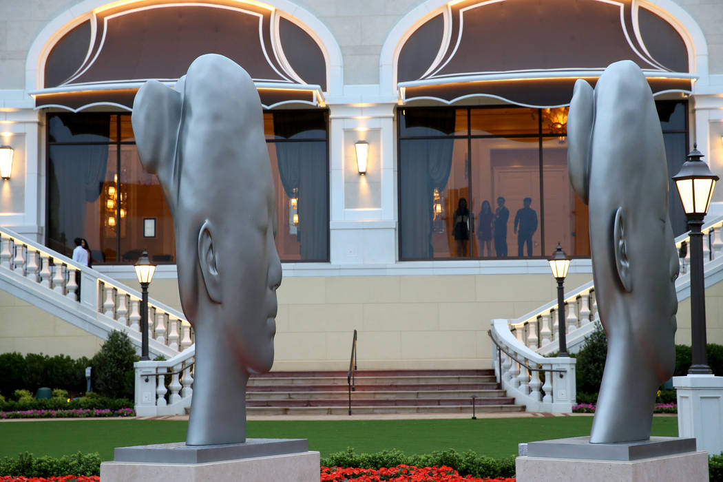 Guests check out an art installation by sculptor Jaume Plensa on the river walk during an invit ...