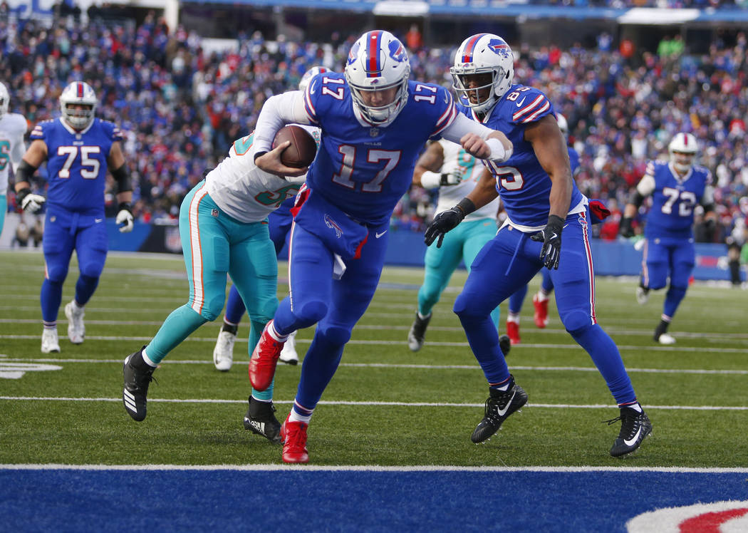 Buffalo Bills quarterback Josh Allen (17) scores a touchdown during the second half of an NFL f ...