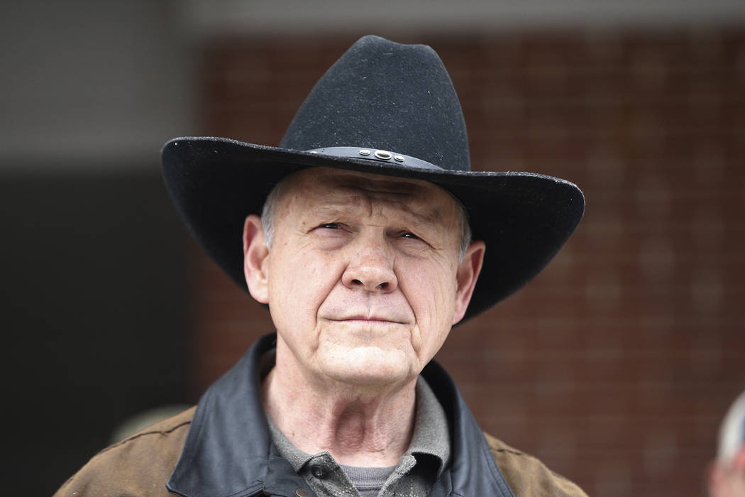 FILE - In this Dec. 12, 2017, file photo, Roy Moore speaks to the media after he rode in on a h ...