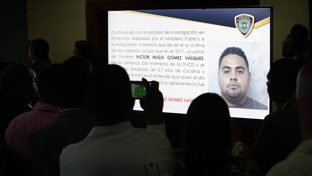 Journalists take pictures of a projection of a man identified by authorities as Victor Hugo Gom ...