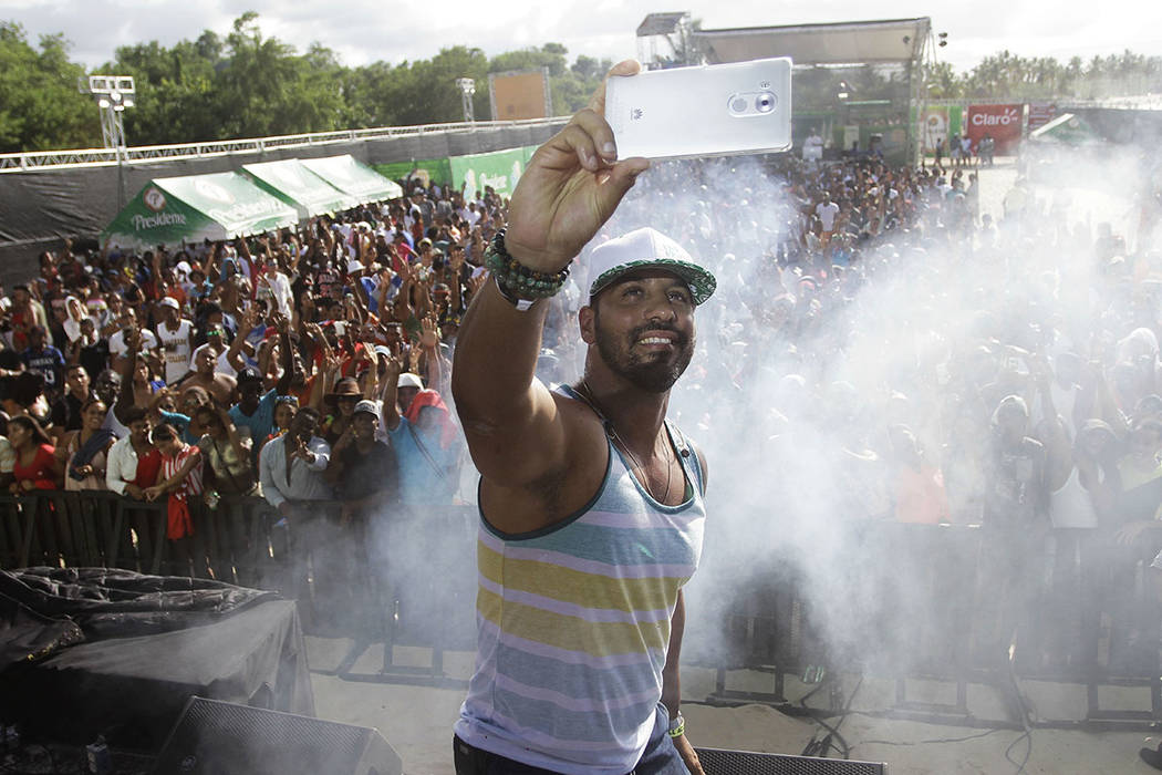 In this Aug. 14, 2016 photo, television presenter Joel Lopez takes a selfie as he works as a pr ...