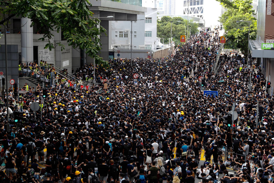 Protesters gather outside the police headquarters in Hong Kong Friday, June 21, 2019. Several h ...