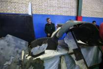 Head of the Revolutionary Guard's aerospace division Gen. Amir Ali Hajizadeh looks at debris fr ...