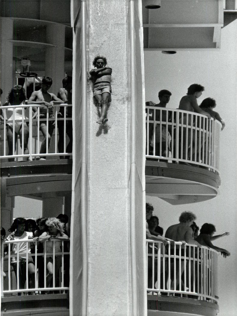 Guests watch as a man slides to the bottom on a slide at Wet 'n Wild on Las Vegas Boulevard in ...