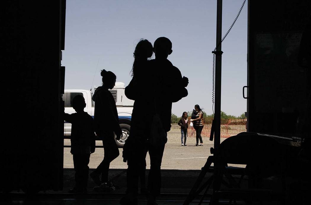 In a Wednesday, May 22, 2019, file photo migrants mainly from Central America guide their chil ...