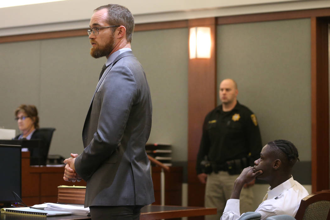 Defense lawyer Chris Peterson, left, speaks at the Regional Justice Center in Las Vegas on Frid ...